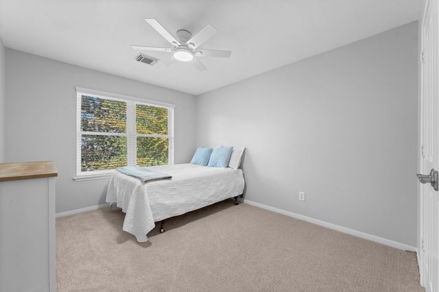 a bed room with a bed and a window