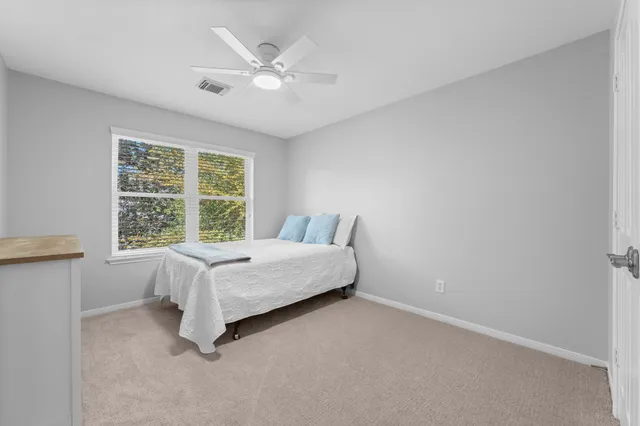 a bed room with a bed and a window