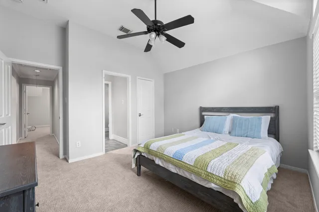 a bedroom with a bed and a ceiling fan