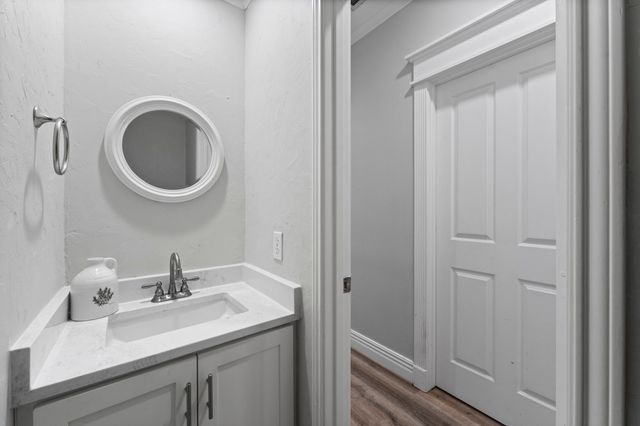 a bathroom with a sink a mirror and toilet