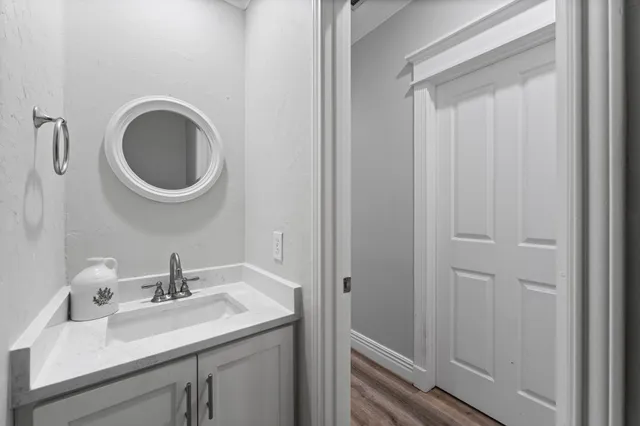 a bathroom with a sink a mirror and toilet