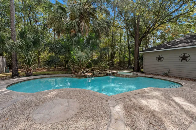 a view of backyard with swimming pool