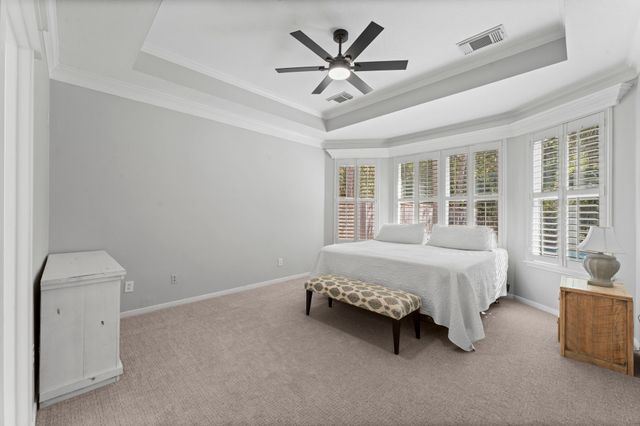 a spacious bedroom with a bed and a large window