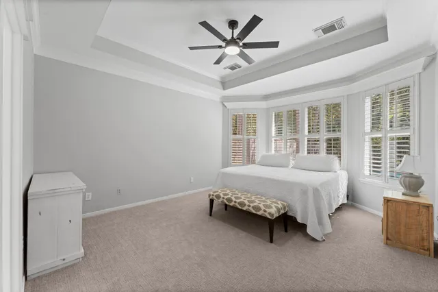 a spacious bedroom with a bed and a large window