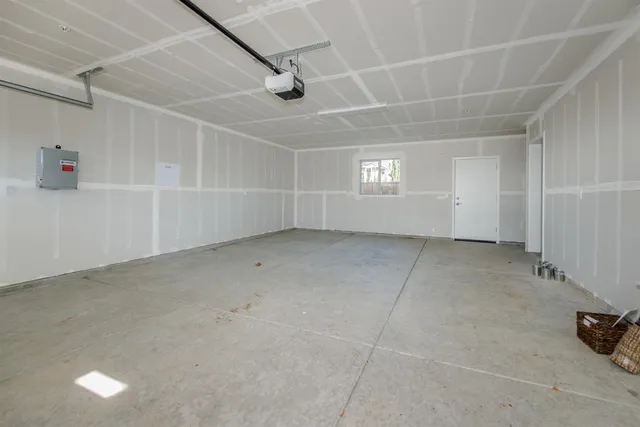 a backyard of a house with plants and trees