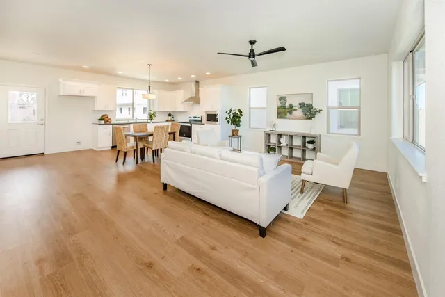 a living room with furniture and a wooden floor