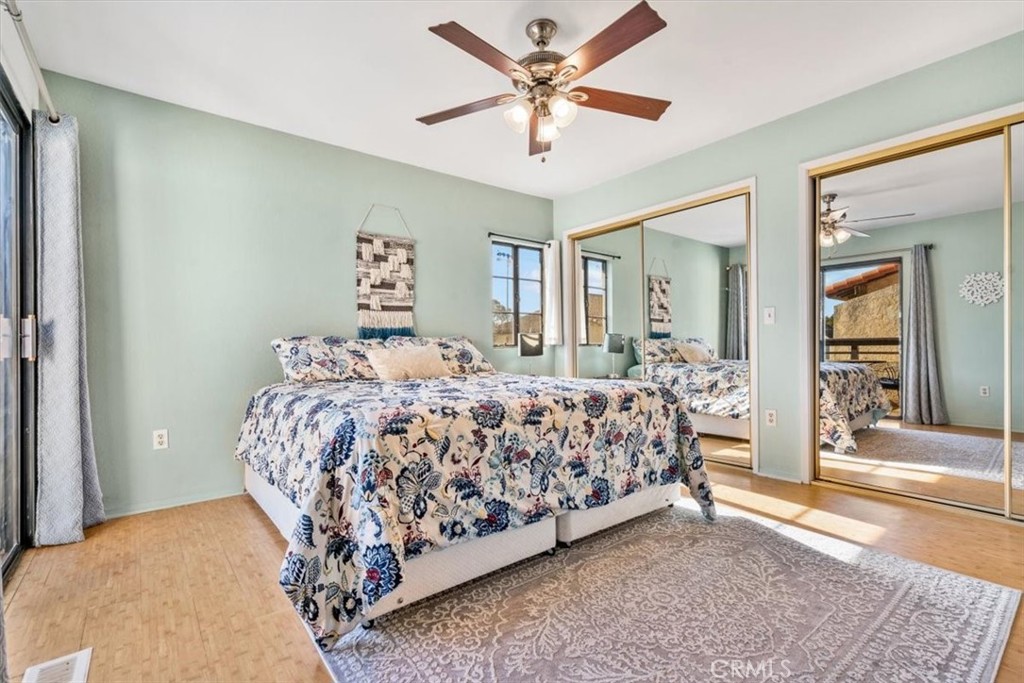 284 Spruce Street Arroyo Grande, CA 93420 - Photo 15 of 31 a bedroom with a large bed and a chandelier fan