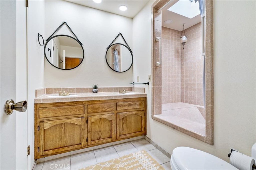 284 Spruce Street Arroyo Grande, CA 93420 - Photo 18 of 31 a bathroom with a toilet a sink and a mirror