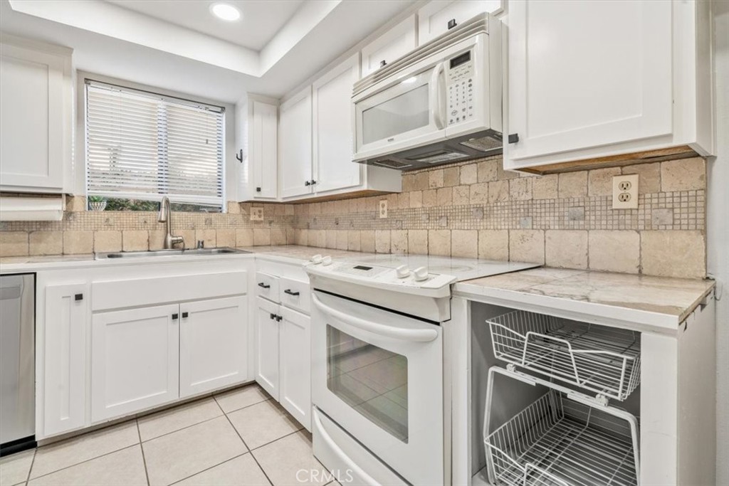 284 Spruce Street Arroyo Grande, CA 93420 - Photo 7 of 31 a kitchen with granite countertop a sink a stove and cabinets