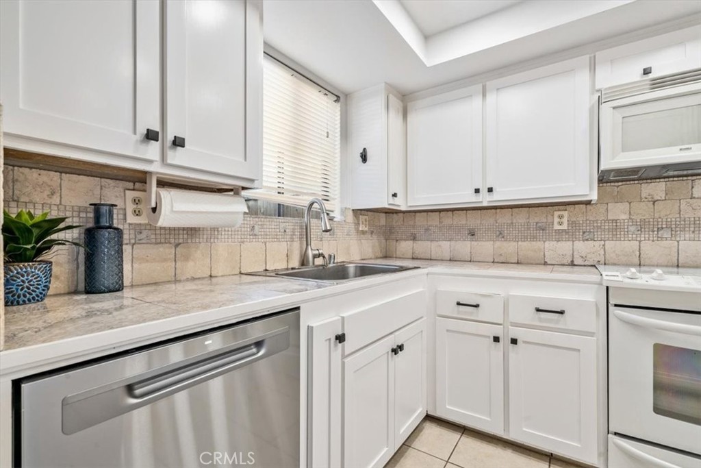 284 Spruce Street Arroyo Grande, CA 93420 - Photo 9 of 31 a kitchen with white cabinets and white appliances