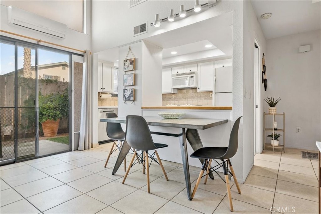 284 Spruce Street Arroyo Grande, CA 93420 - Photo 10 of 31 a dining room with furniture and a floor to ceiling window