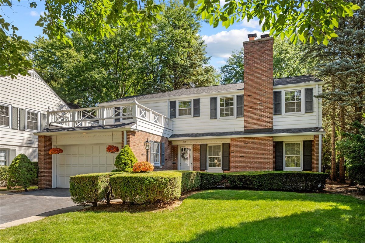 912 Pontiac Road Wilmette, IL 60091 - Photo 1 of 25 a front view of a house with a garden