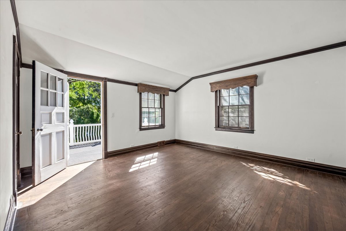 912 Pontiac Road Wilmette, IL 60091 - Photo 15 of 25 an empty room with wooden floor and windows