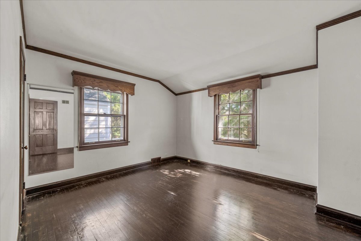 912 Pontiac Road Wilmette, IL 60091 - Photo 18 of 25 an empty room with wooden floor and windows