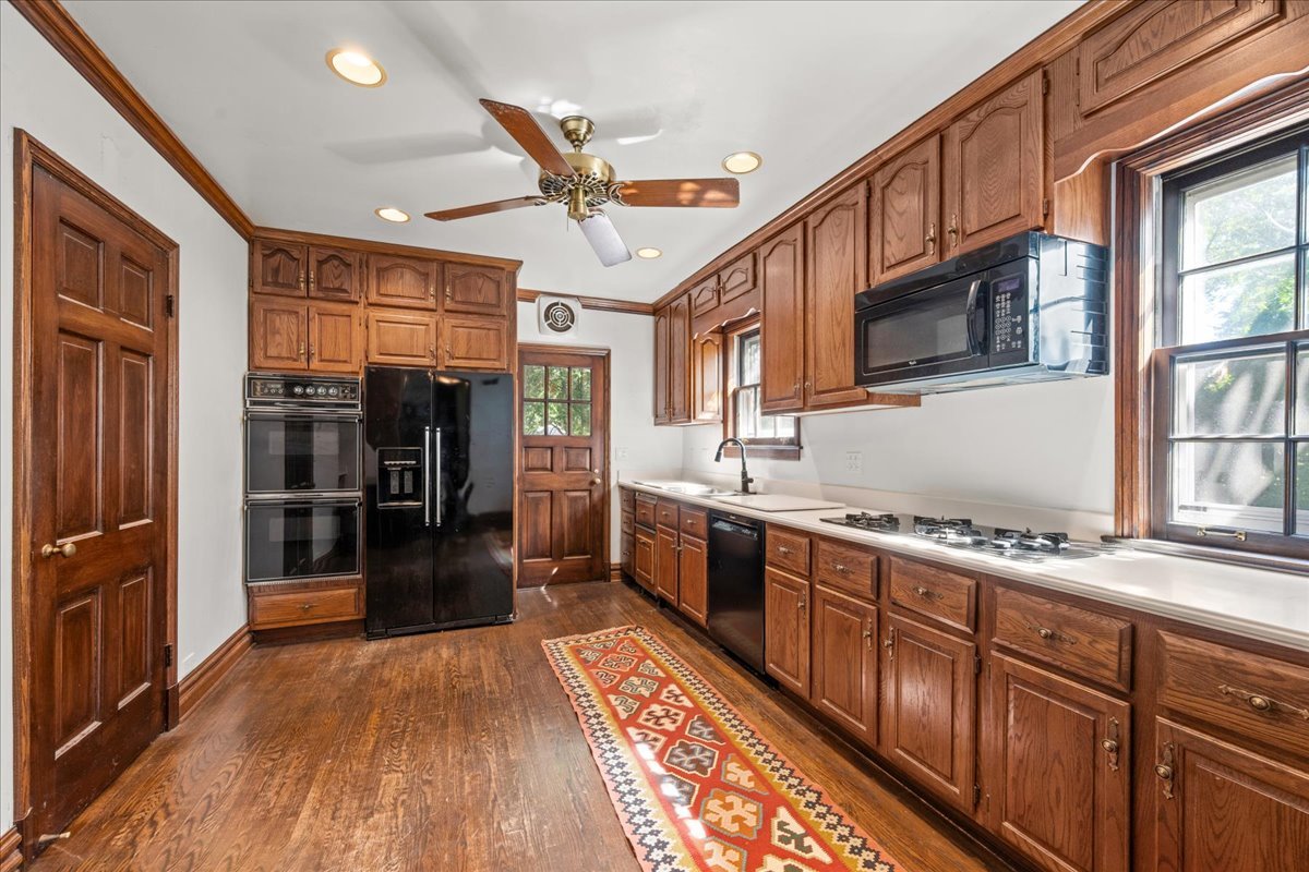 912 Pontiac Road Wilmette, IL 60091 - Photo 6 of 25 a kitchen with stainless steel appliances granite countertop a refrigerator a sink dishwasher a stove and white countertops with wooden floor