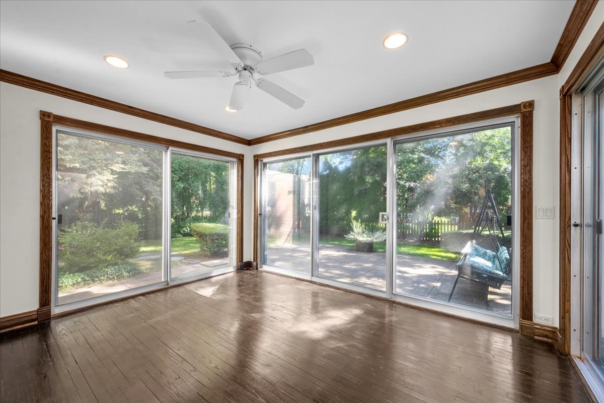 912 Pontiac Road Wilmette, IL 60091 - Photo 9 of 25 a view of an empty room with wooden floor and a window