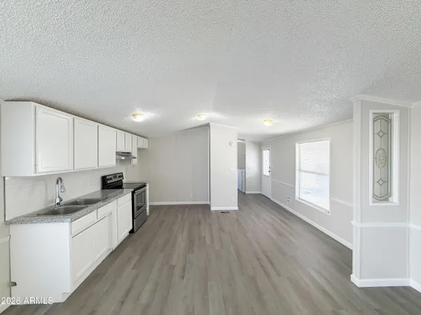 a large kitchen with stainless steel appliances granite countertop a stove and a refrigerator