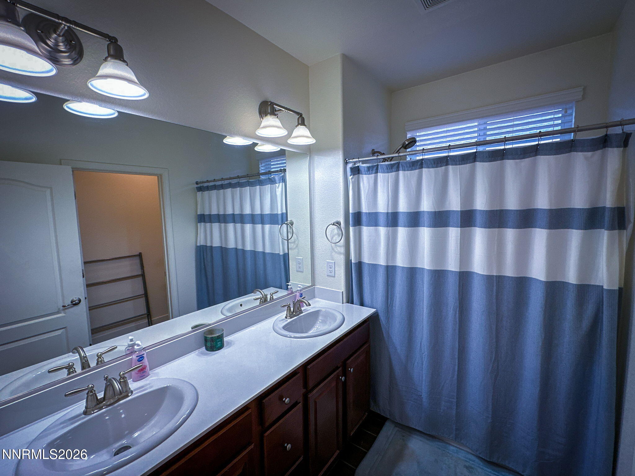 7330 Overture Drive Reno, NV 89506 - Photo 13 of 17 a bathroom with a double vanity sink double vanity and a mirror