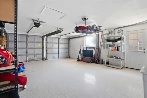 a view of a living room with furniture and floor to ceiling window