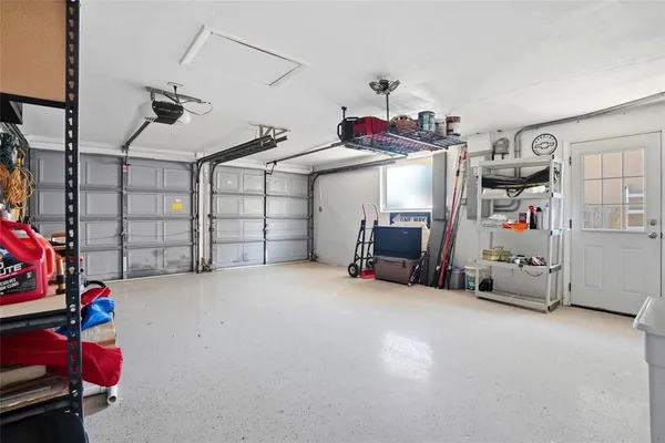 a view of a living room with furniture and floor to ceiling window