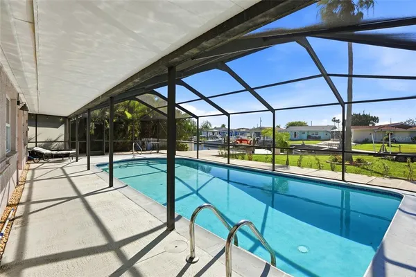a view of a house with swimming pool in front of it