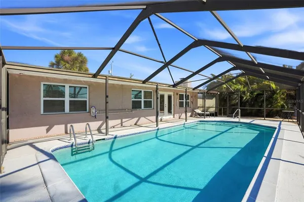 a view of a swimming pool with an outdoor seating and a yard