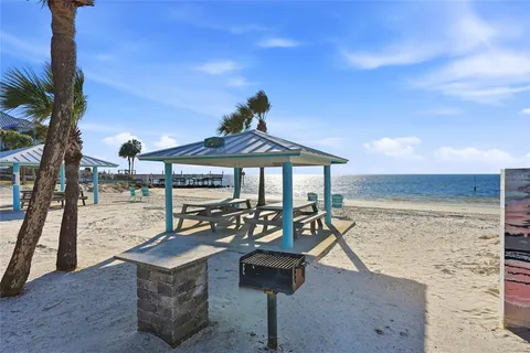 a view of a patio with a table and chairs under an umbrella