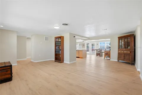 a view of an empty room with furniture and closet