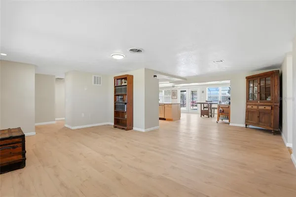 a view of an empty room with furniture and closet