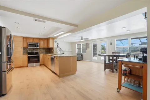 a large kitchen with a table and chairs in it
