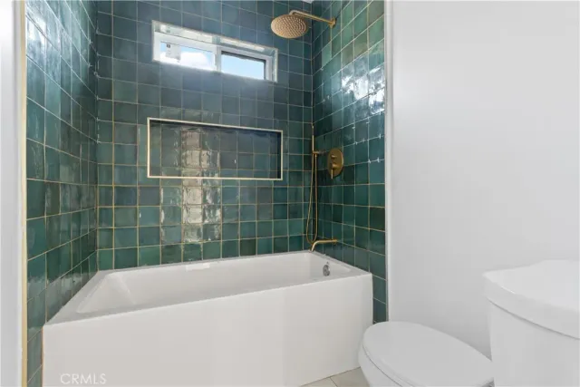 a bathroom with a bathtub and window