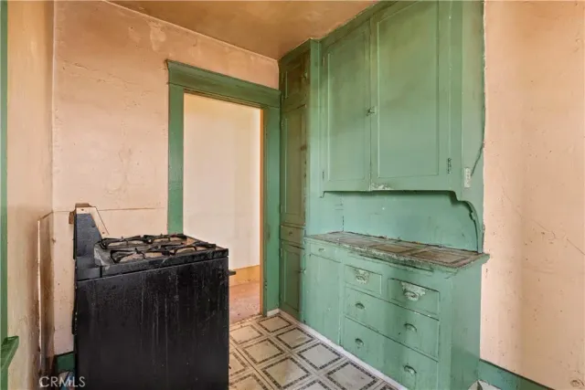 a kitchen with a refrigerator and a sink