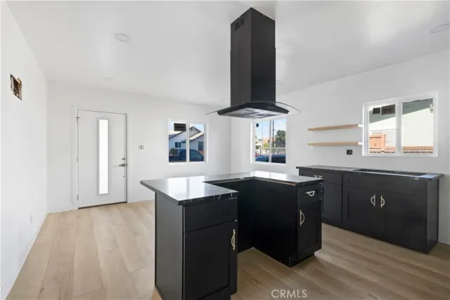 a kitchen with stainless steel appliances kitchen island granite countertop a sink and cabinets
