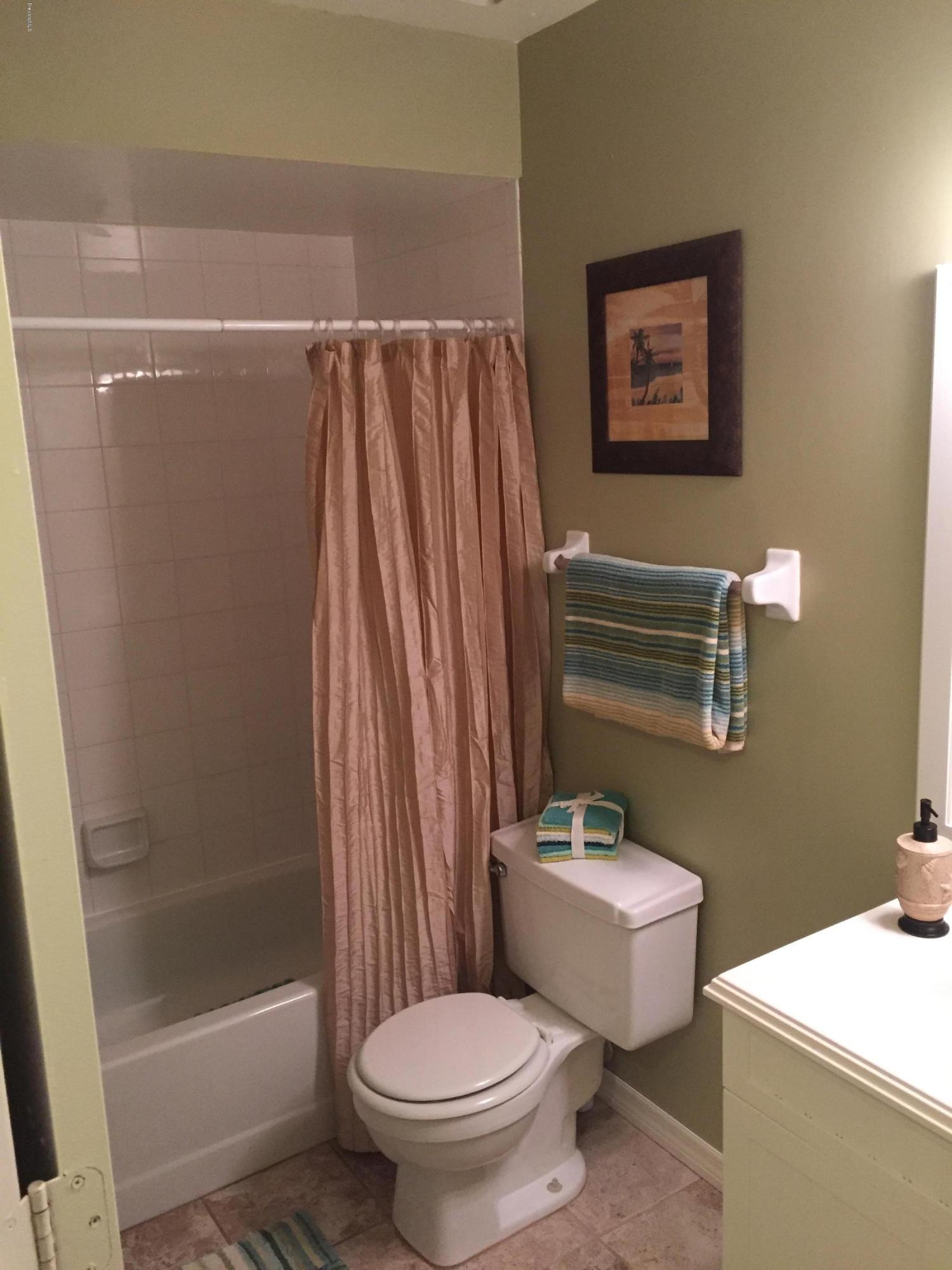 5330 Holden Road Cocoa, FL 32927 - Photo 13 of 23 a white toilet sitting next to a bathroom sink