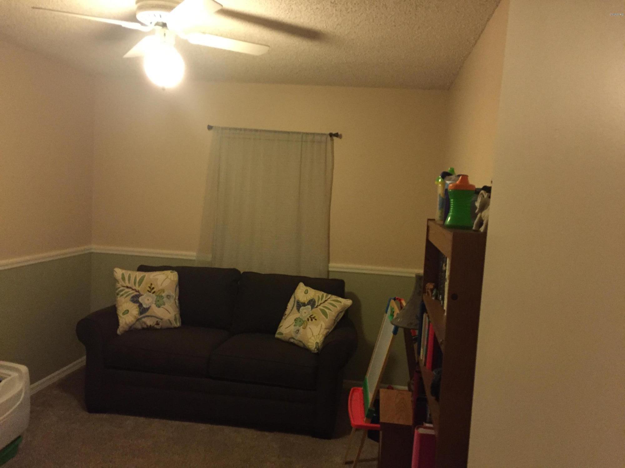 5330 Holden Road Cocoa, FL 32927 - Photo 14 of 23 a couch sitting in a room next to a blue wall