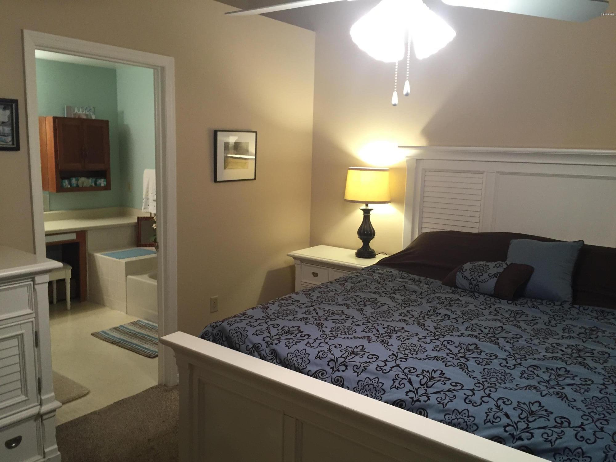 5330 Holden Road Cocoa, FL 32927 - Photo 15 of 23 a large bed sitting in a bedroom next to a lamp