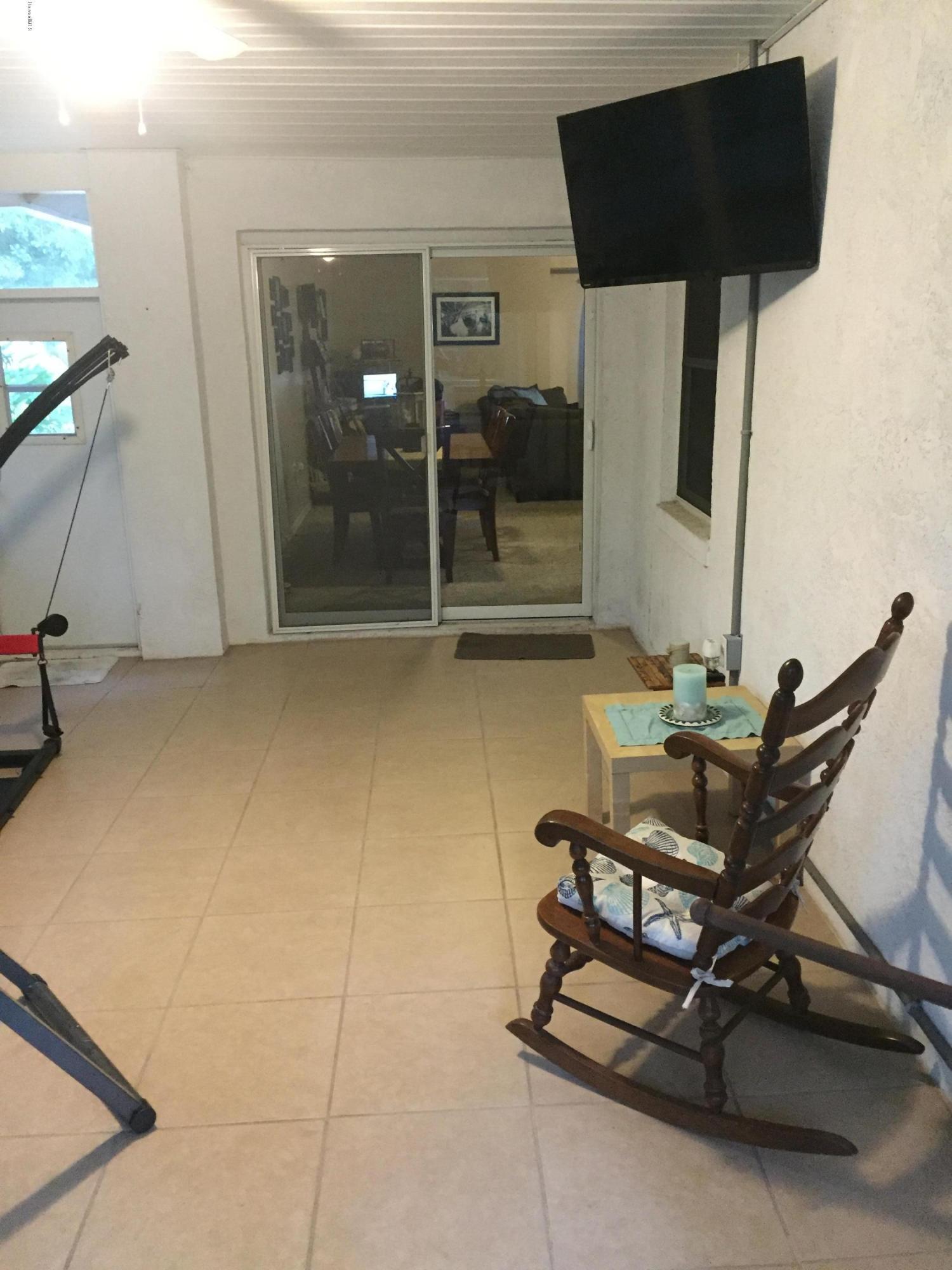 5330 Holden Road Cocoa, FL 32927 - Photo 21 of 23 a living room with a couch and a table