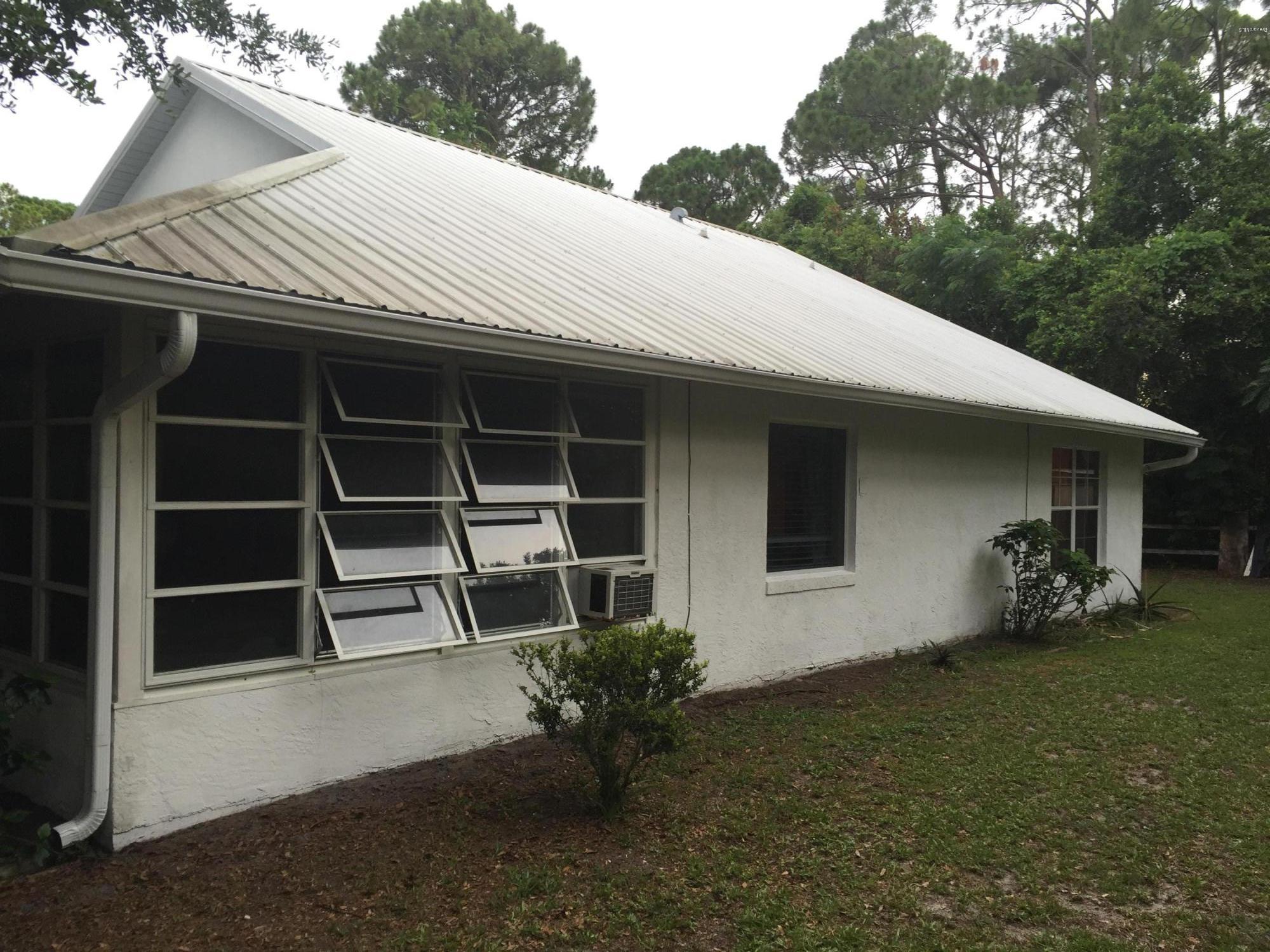 5330 Holden Road Cocoa, FL 32927 - Photo 4 of 23 a house with trees in the background
