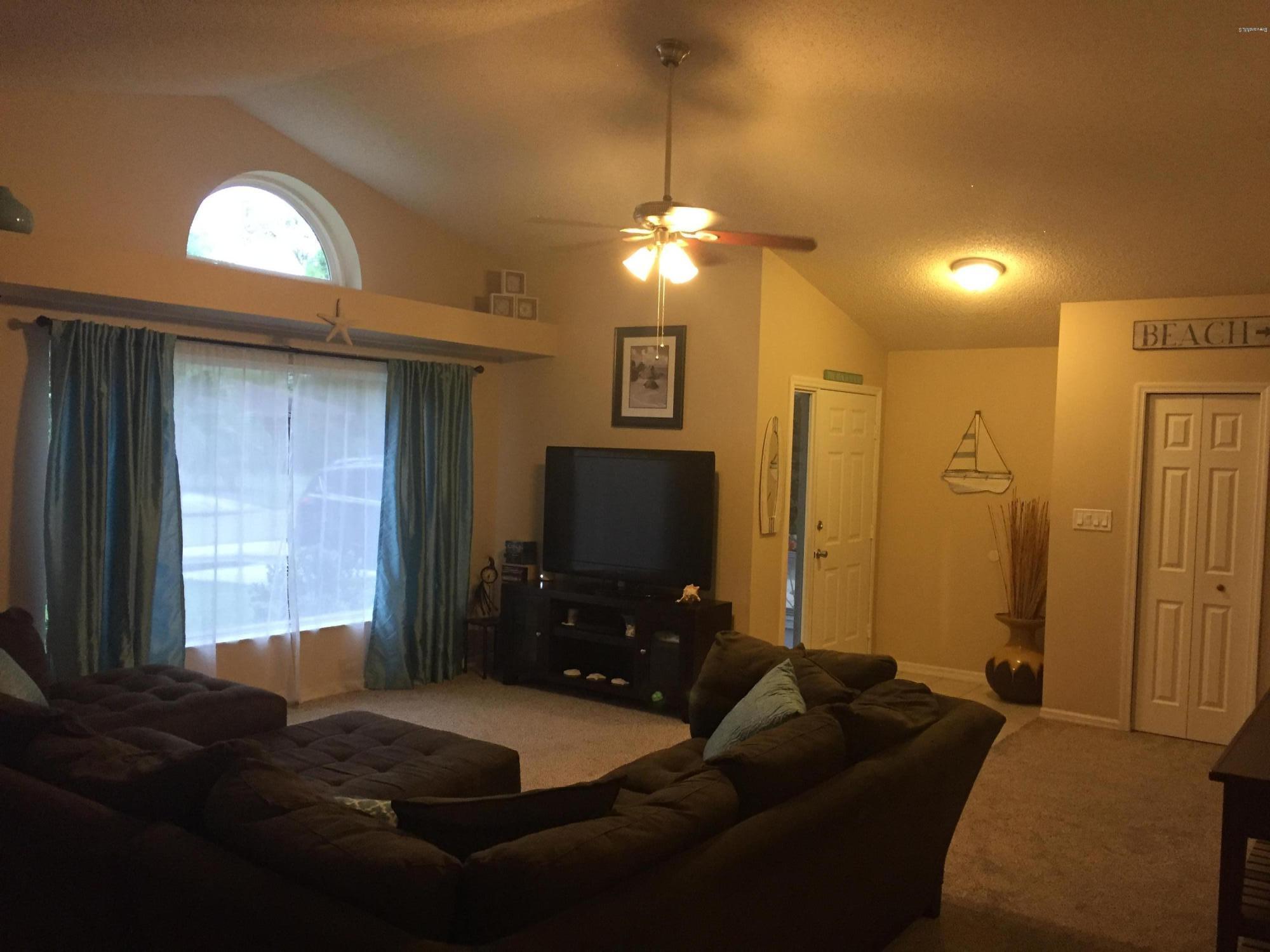 5330 Holden Road Cocoa, FL 32927 - Photo 8 of 23 a living room with furniture and a flat screen tv