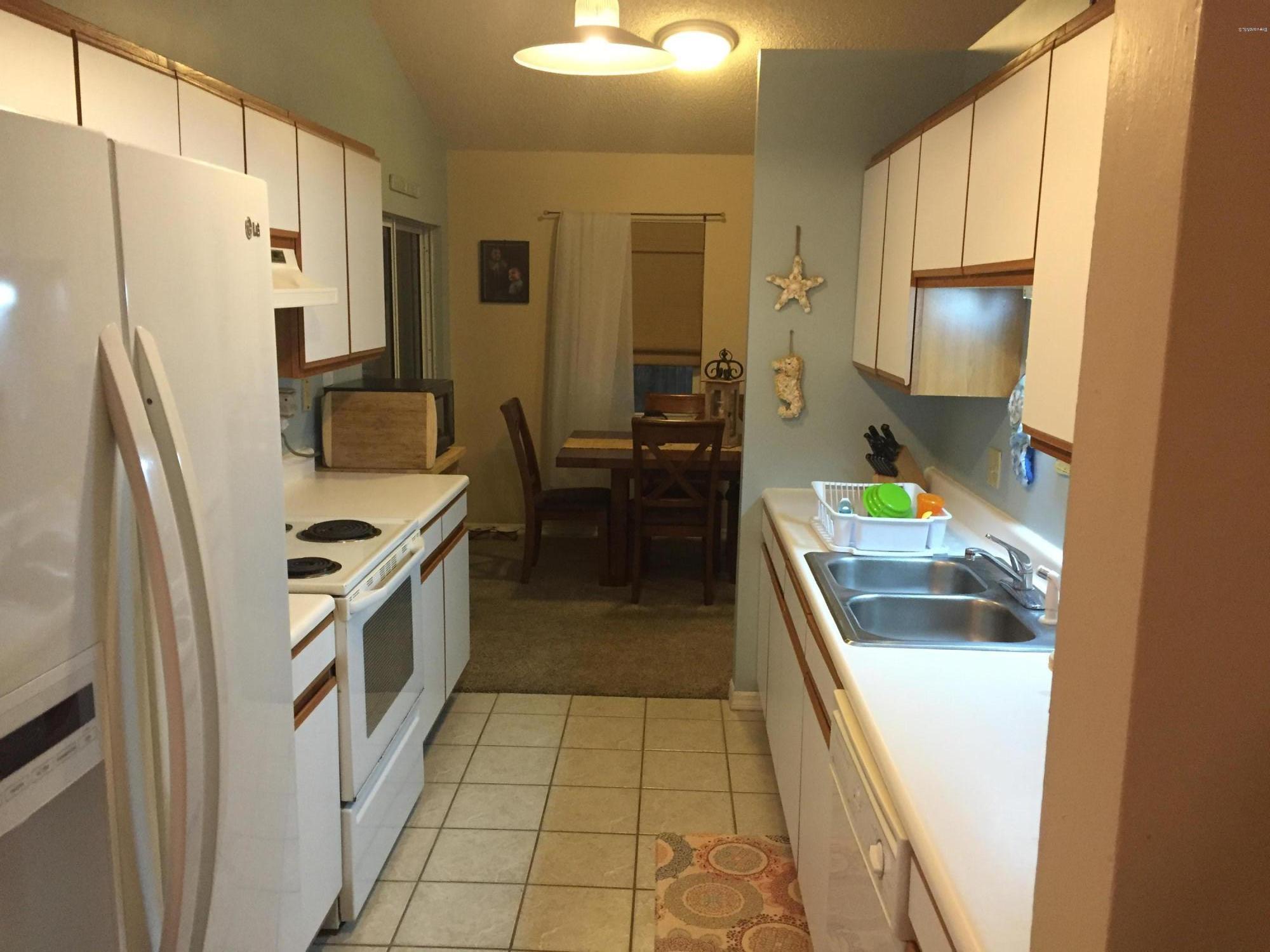 5330 Holden Road Cocoa, FL 32927 - Photo 10 of 23 a kitchen with a refrigerator a stove and a sink