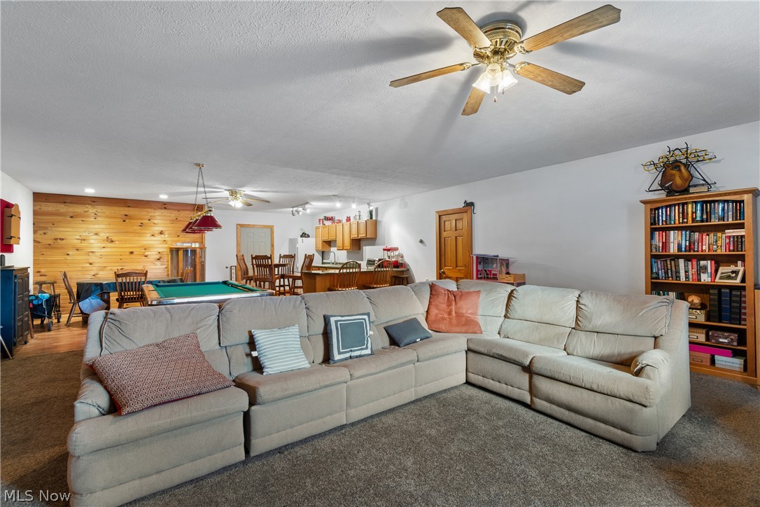 29395 Beitler Road Dennison, OH 44621 - Photo 28 of 33 Garage suite area with a ceiling fan, carpet floors, pool table, wooden walls, and recessed lighting