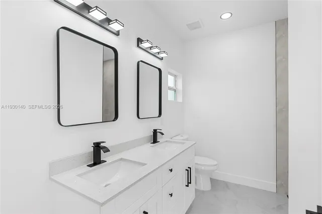 an empty room with a cabinet and mirrors