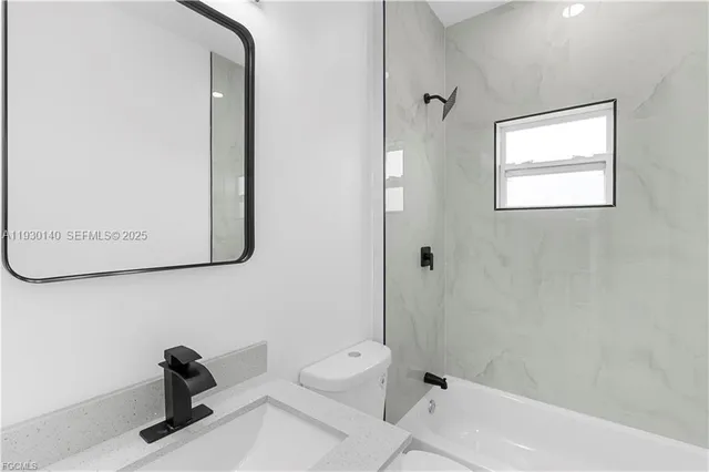 a kitchen with a sink cabinets and stainless steel appliances