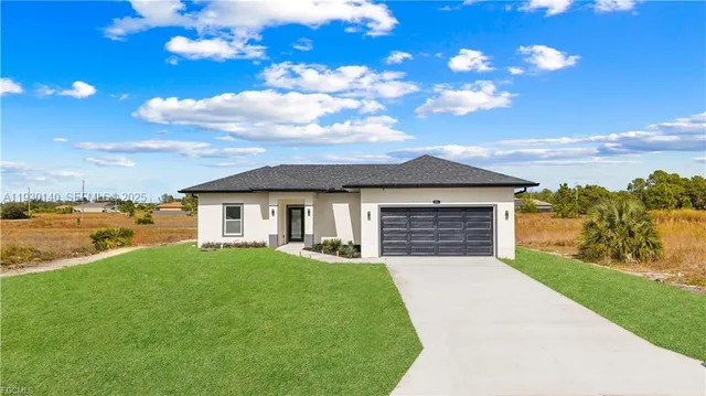 a view of a house with a yard and ocean view