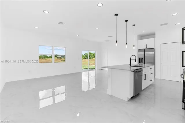 a kitchen with a sink cabinets and stainless steel appliances