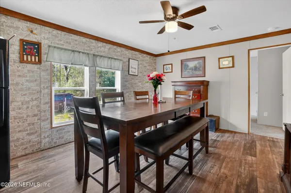 a view of a dining room with furniture window and wooden floor