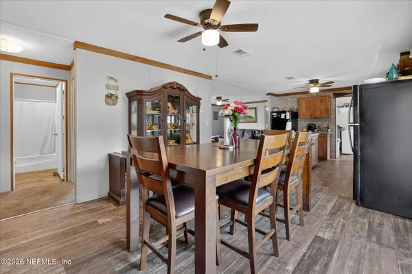a view of a dining room with furniture and wooden floor