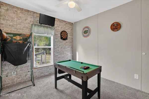 a room with work table and chairs