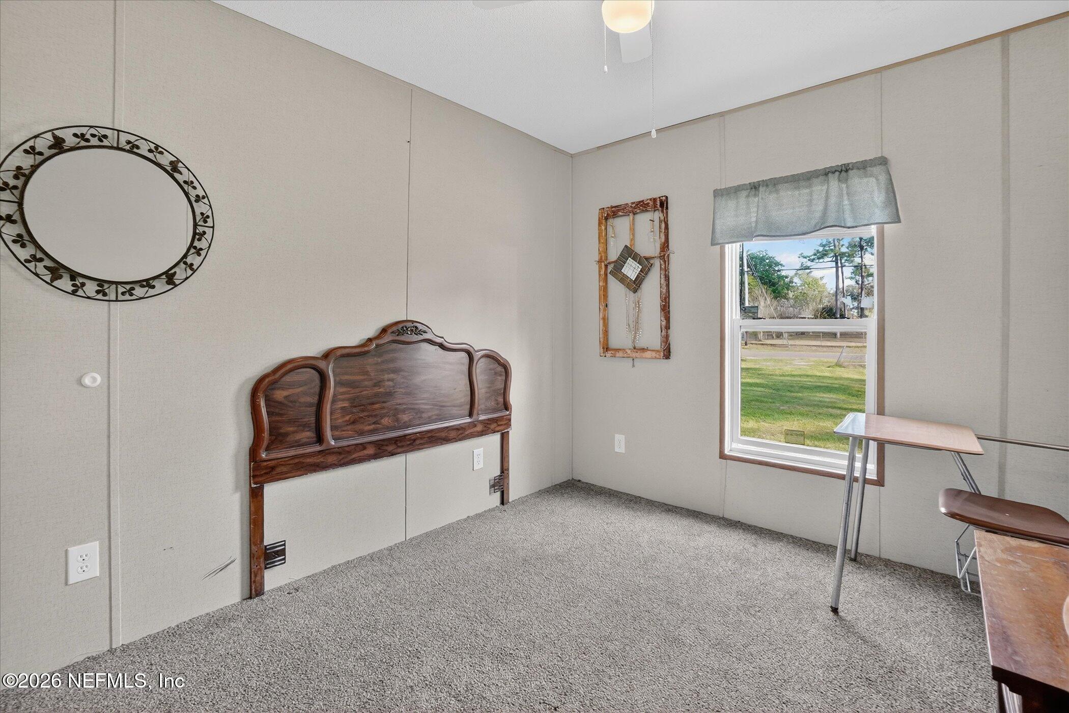 85405 Blackmon Road Yulee, FL 32097 - Photo 14 of 27 a bathroom with a granite countertop tub a sink and a window