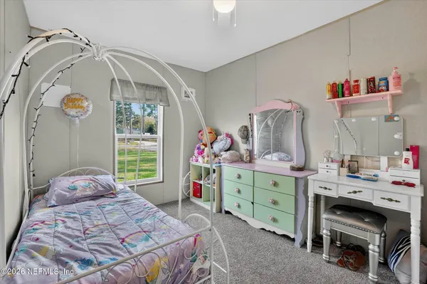 a bedroom with a bed and a dresser